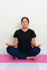 Asian young women doing yoga meditation above sport mattress