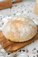 Ciabatta bread on oven tray on terrazzo counter in kitchen