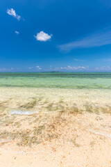 Blue sky, crystal clear water, gentle waves on the wild beach of Iriomote island..