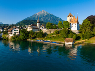 Fototapeta premium Picturesque castle and church of Spiez at lake Thun, with mount Niesen in the background, Switzerland 