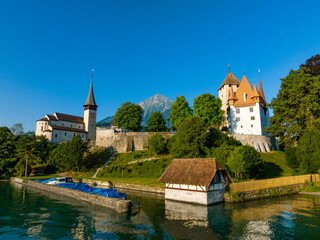 Picturesque castle and church of Spiez at lake Thun, with mount Niesen in the background, Switzerland 