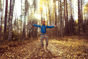 follow me on a hike, a man invites you to a forest hike, autumn landscape in the forest in nature