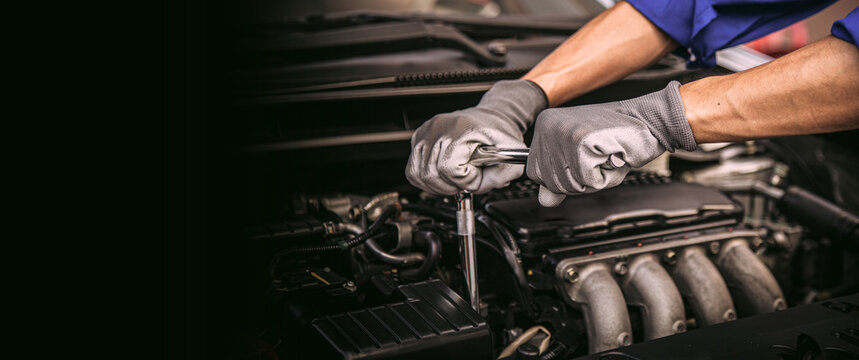 Car care maintenance and servicing, Close-up hand technician auto mechanic using the wrench to repairing change spare part car engine problem and car insurance service support.