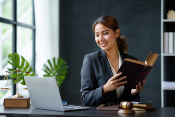 Lawyer concept. Beautiful Asian lawyer woman is reviewing various legal clauses to support the case...