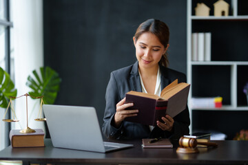 Lawyer concept. Beautiful Asian lawyer woman is reviewing various legal clauses to support the case file The results of the legal proceedings with the client.