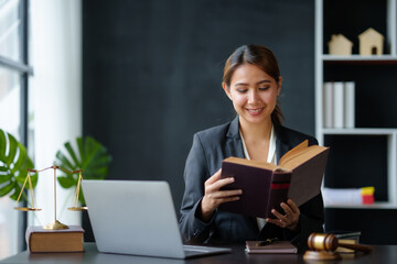 Lawyer concept. Beautiful Asian lawyer woman is reviewing various legal clauses to support the case file The results of the legal proceedings with the client.