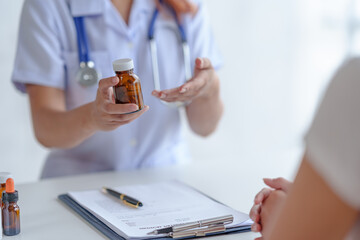 Doctor is explaining to the patient information about the use of the drug, the indication, how to take it side effect of the drug and the patient's medication history record.