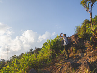 Trekker enjoying on mountain trail in tropical forest