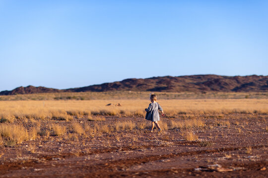 Pilbara Landscape With Blue Sky And Small Child In Mid Ground