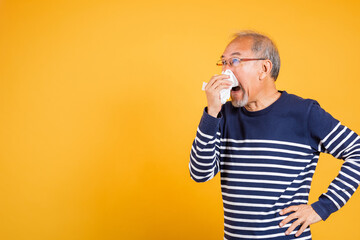 Asian elder man cold having flu and sneezing from sickness virus problem use tissue studio shot...
