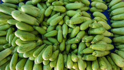 A bunch of zucchini on the bazaar counter.