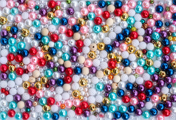 Horizontal textured background of colored beads. close-up of a lot of bright multi-colored beads. Colorful background. Texture background