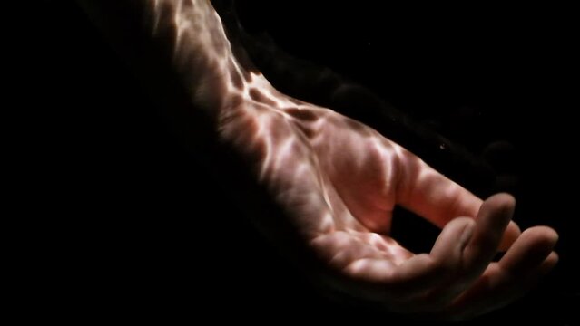 Lifeless hand floating under water on a black background. Rescue of drowning concept.