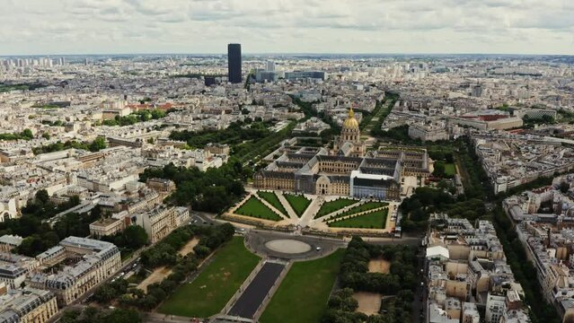 Architectural complex and park area of Les Invalides in the historic center of Paris, bird's eye view video on a cloudy day. Cityscape of Paris from drone, France