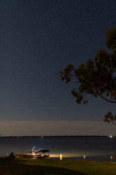Fishing rod lights on lake jetty at night