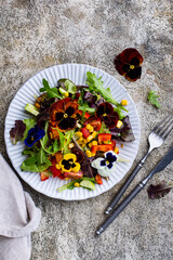 Vegetable salad with edible flowers