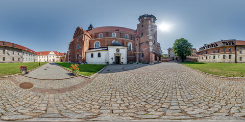 full 360 panorama on near catholic gothic church red brick walls in old town with historical...