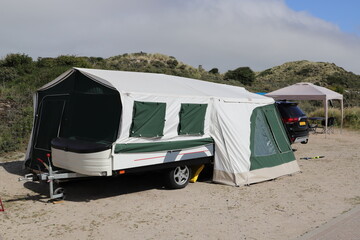 an folding caravan on a campsite  - obrazy, fototapety, plakaty