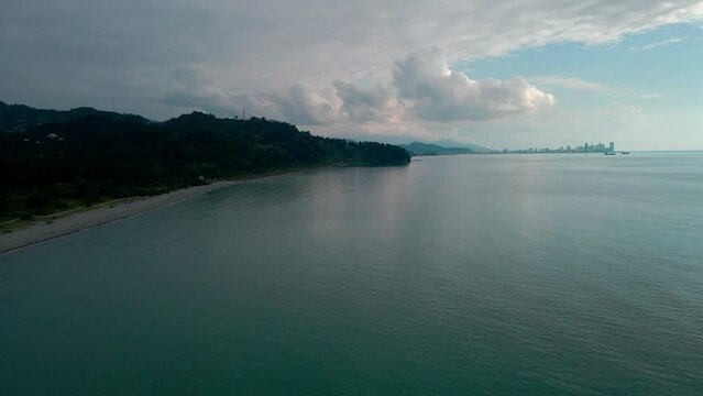 Black Sea beach and embankment with vacationers and infrastructure. Drone flight over Ureki.