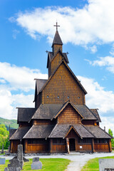 Fototapeta na wymiar The Stave Church is crowned with crosses