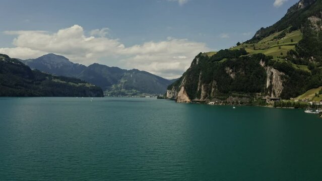Horizontal panning from a drone, a view of a picturesque mountain valley with a beautiful large lake at the foot of the mountains. Switzerland, Lucerne, Alps