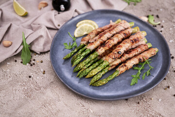 Healthy food - Asparagus wrapped with bacon and spices on a plate