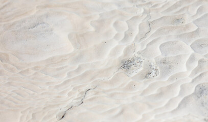 White volcanic limestone rock as background.