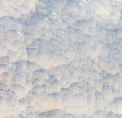White volcanic limestone rock as background.