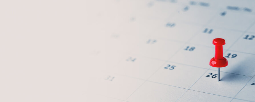 Embroidered red pins on a calendar event Planner calendar,clock to set timetable organize schedule,planning for business meeting or travel planning concept.