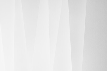 White abstract geometric background with soft light paper inclined vertical lines or surfaces with...