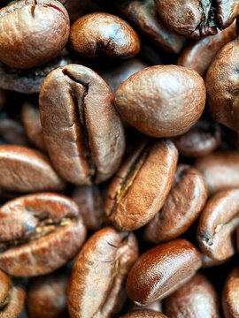 Macro view of fresh coffee beans background or wallpaper. © greola84