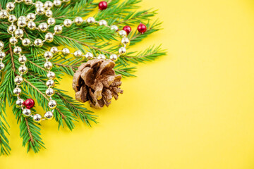 Merry Christmas and Happy New Year! green fir branches, cones, garlands and lights. Copyspace for a...
