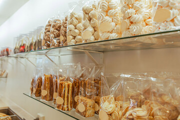 Traditional European bakery shop interior display, meringue, pastry twist, almond biscuit cookies,...