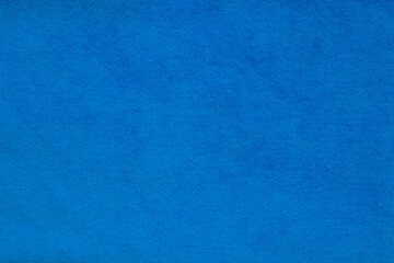 Blue velvet fabric surface from above. velvet texture violet color background. expensive luxury fabric, material, wallpaper.