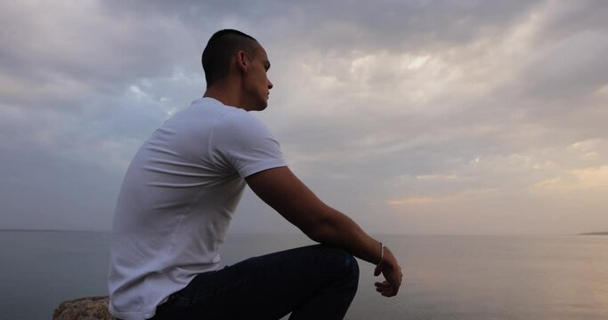 Dramatic sky, man looking at the clouds thinking about future of his life