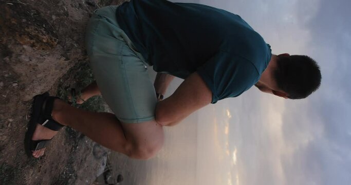 Dramatic sky, man looking at the clouds thinking about future of his life, vertical video