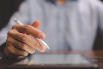 professional business person using hand to working with date on digital tablet, modern internet communication technology, businessman or office man working on screen surface of computer laptop device