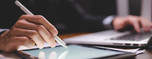 professional business person using hand to working with date on digital tablet, modern internet communication technology, businessman or office man working on screen surface of computer laptop device