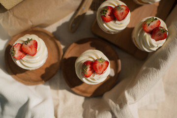 Delicious pastries at a picnic in the park, decorated with strawberries in a basket