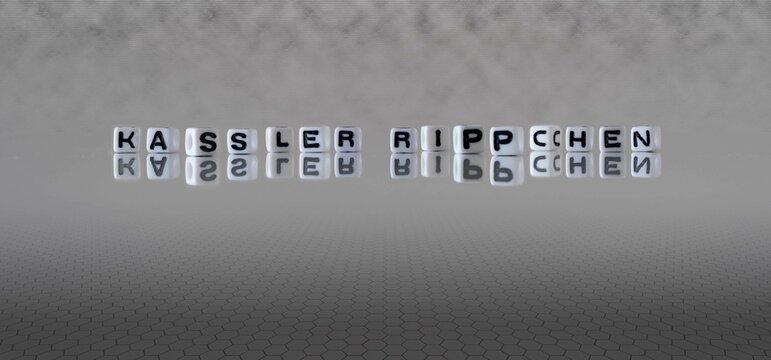 kassler rippchen Wort oder Konzept dargestellt durch schwarze und wei&szlig;e Buchstabenw&uuml;rfel auf einem grauen Horizonthintergrund