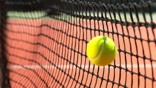 Super Slow Motion Shot of Tennis Ball Hitting the Net on Court at 1000fps.