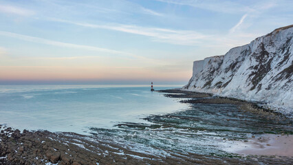Epic vibrant Summer dawn landscape image of Beachy Head Lighthouse in South Downs National Park in...