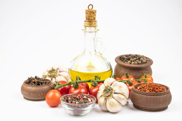 Vegetables and spices, olive oil in a bottle isolated on a white background.