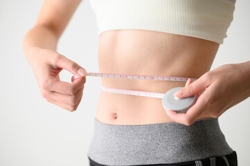 Image of measuring the waist in a diet - obrazy, fototapety, plakaty