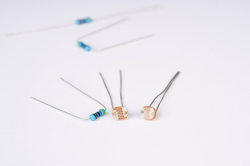 Electronic parts photoresistor and resistor on the white background.