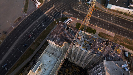 Construction site of a new city block. Construction of multi-storey buildings. Construction site at dawn. Aerial photography.