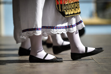 Traditional greek costume detail during a dance performance - 526456398