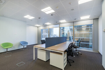 Bright office with furniture in a modern building with a panoramic window