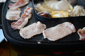 barbecue gril on black pot with meat and vegetable