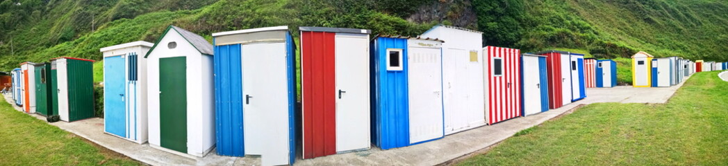 typical colored bathing huts on the beach of Luarca, Asturias, Spain,